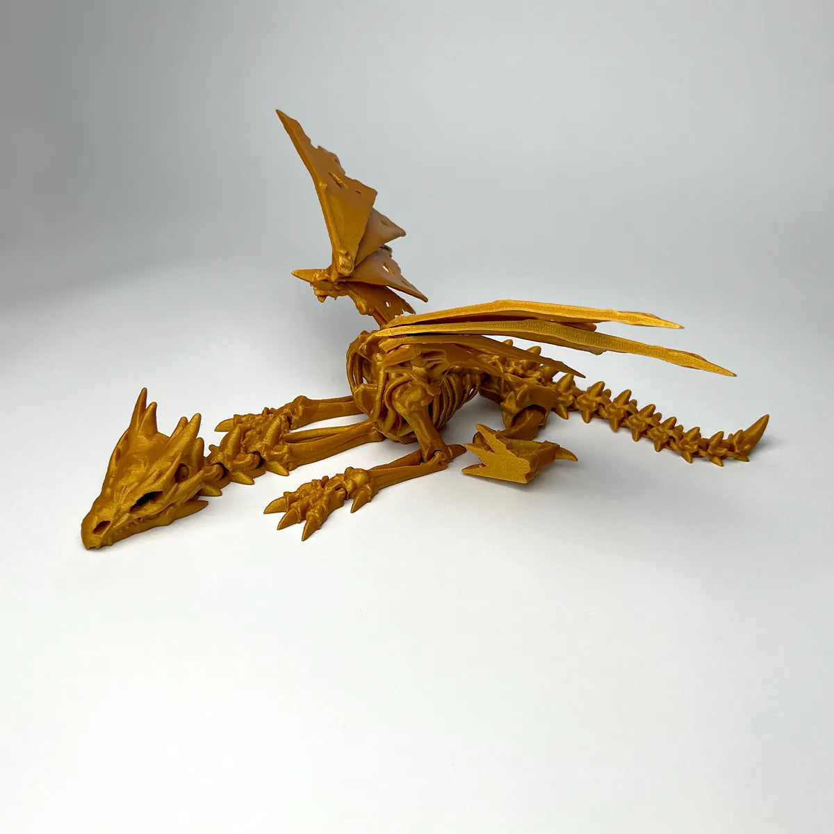 Wraithwing Skeleton Dragon Fidget held in hand for scale